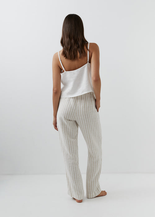 Back view of high-waisted striped linen trousers in beige and white.