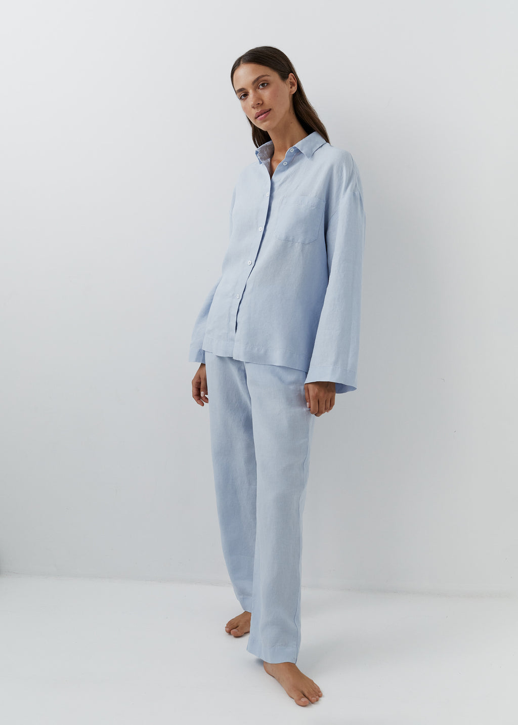 Light blue linen trousers with a relaxed straight-leg silhouette.