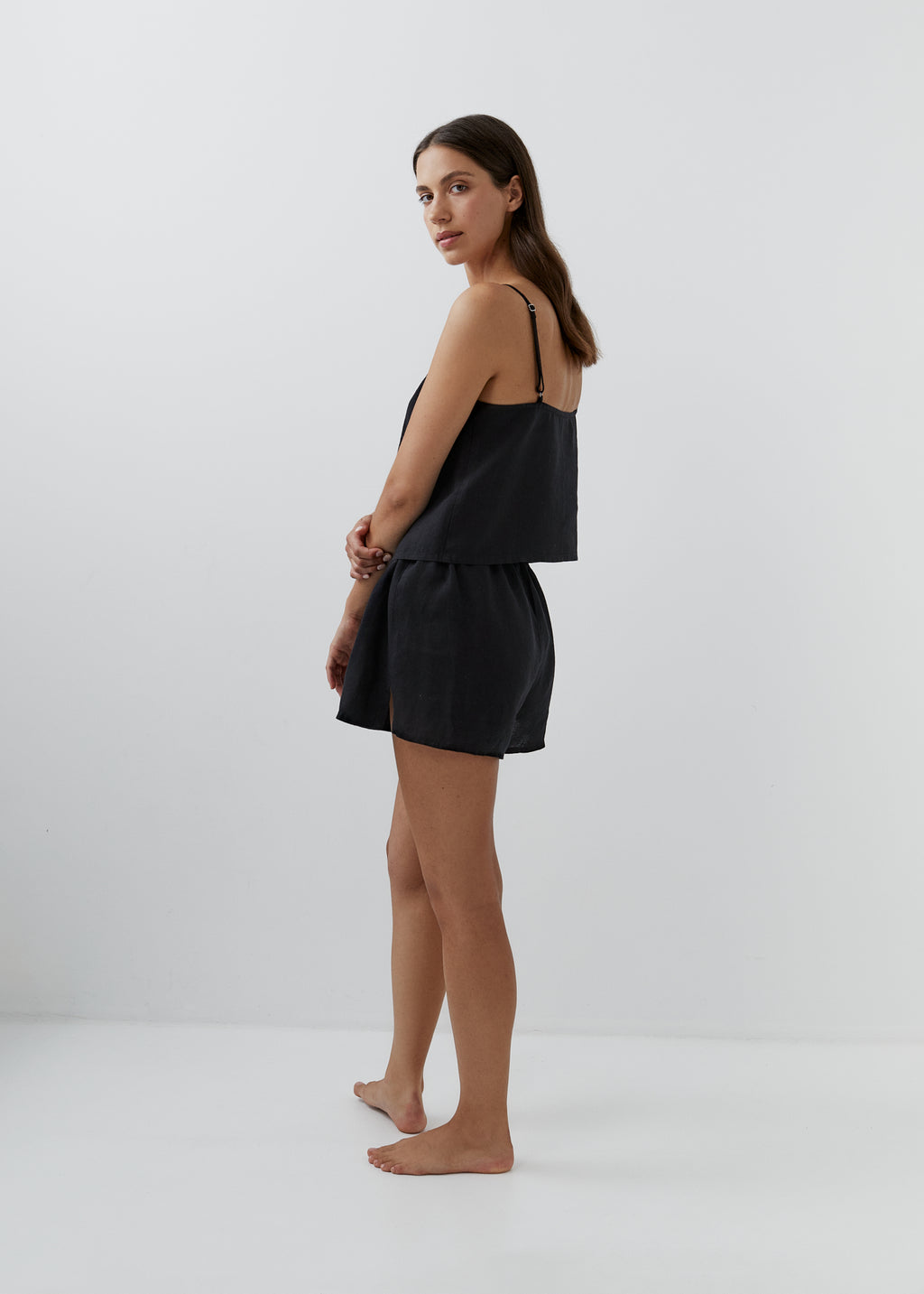Women’s black linen pyjamas with a camisole top and matching high-waisted shorts.