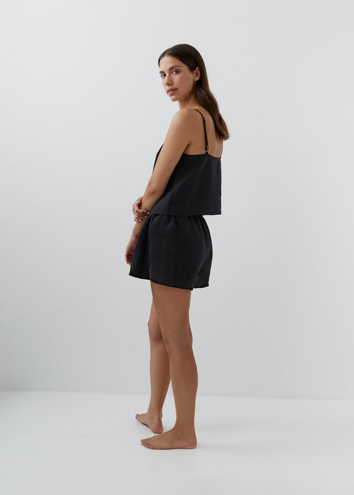 Women’s black linen pyjamas with a camisole top and matching high-waisted shorts.