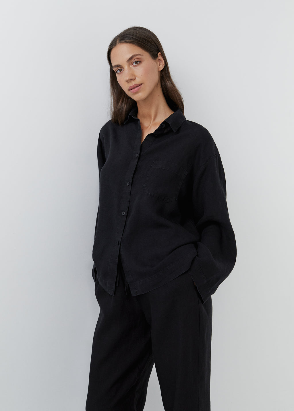 Black linen sleepwear set for women with a relaxed shirt and matching trousers.
