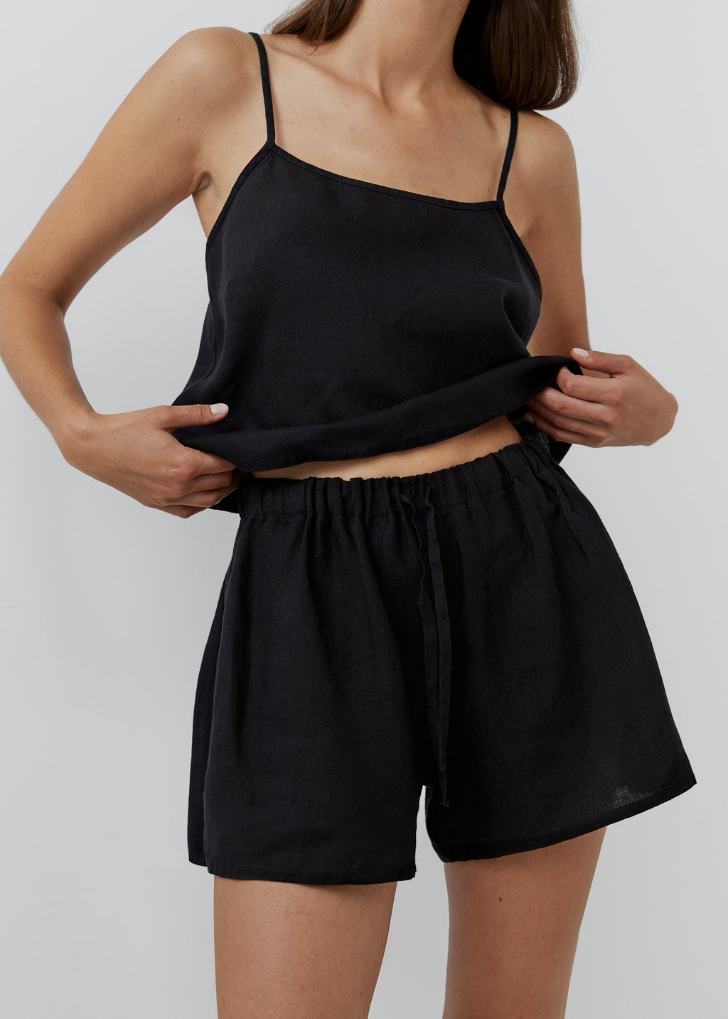 Black linen pajama shorts with a high waist and elasticated drawstring waistband.